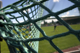 Grossaufnahme – Blick durch Tornetz auf Sportplatz.